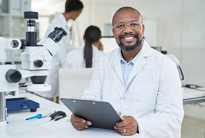 Buy stock photo Portrait of a mature scientist going through paperwork in a lab