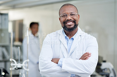 Buy stock photo Portrait of a mature scientist standing with his arms crossed in a lab