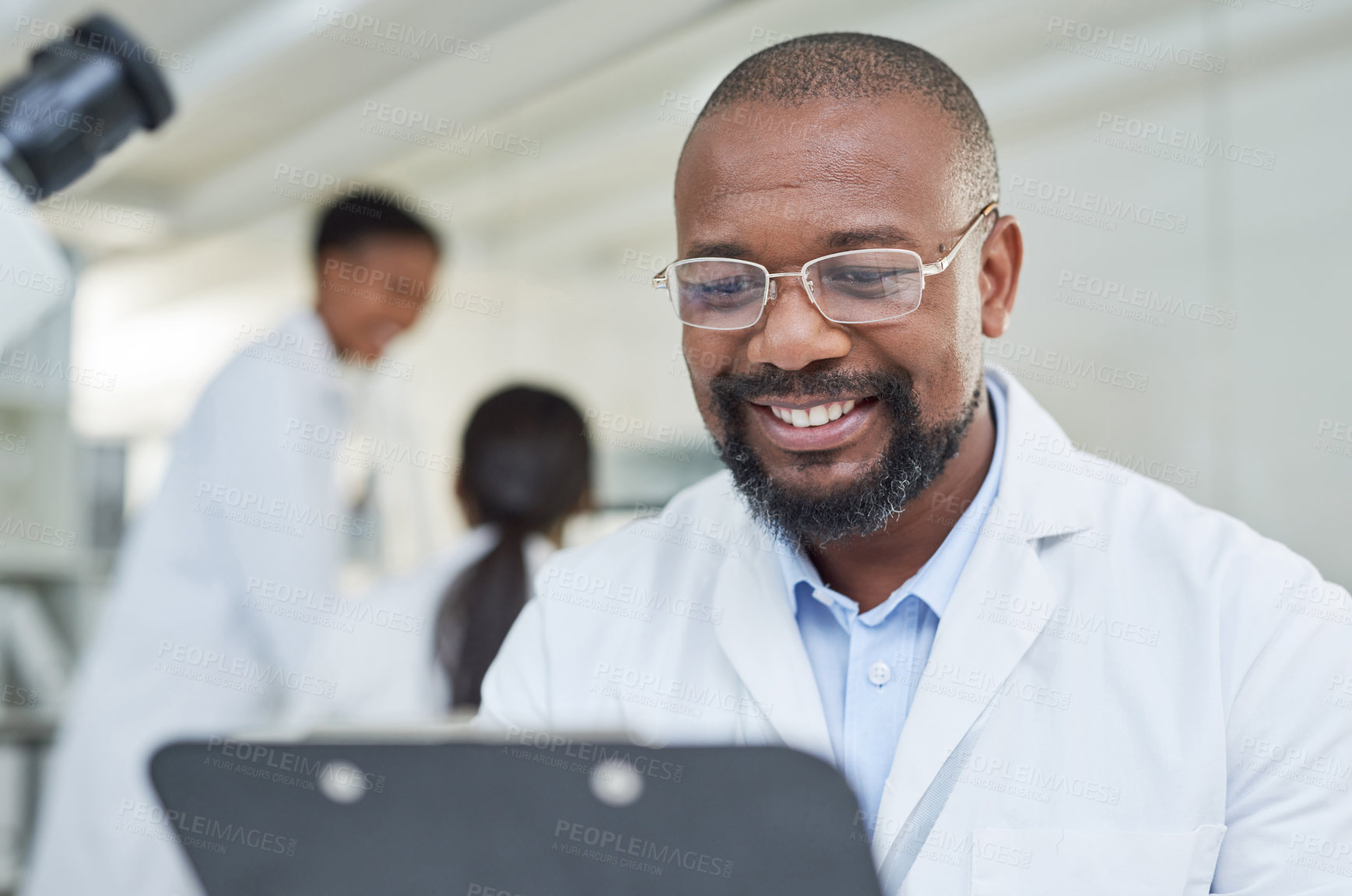 Buy stock photo Shot of a mature scientist going through paperwork in a lab