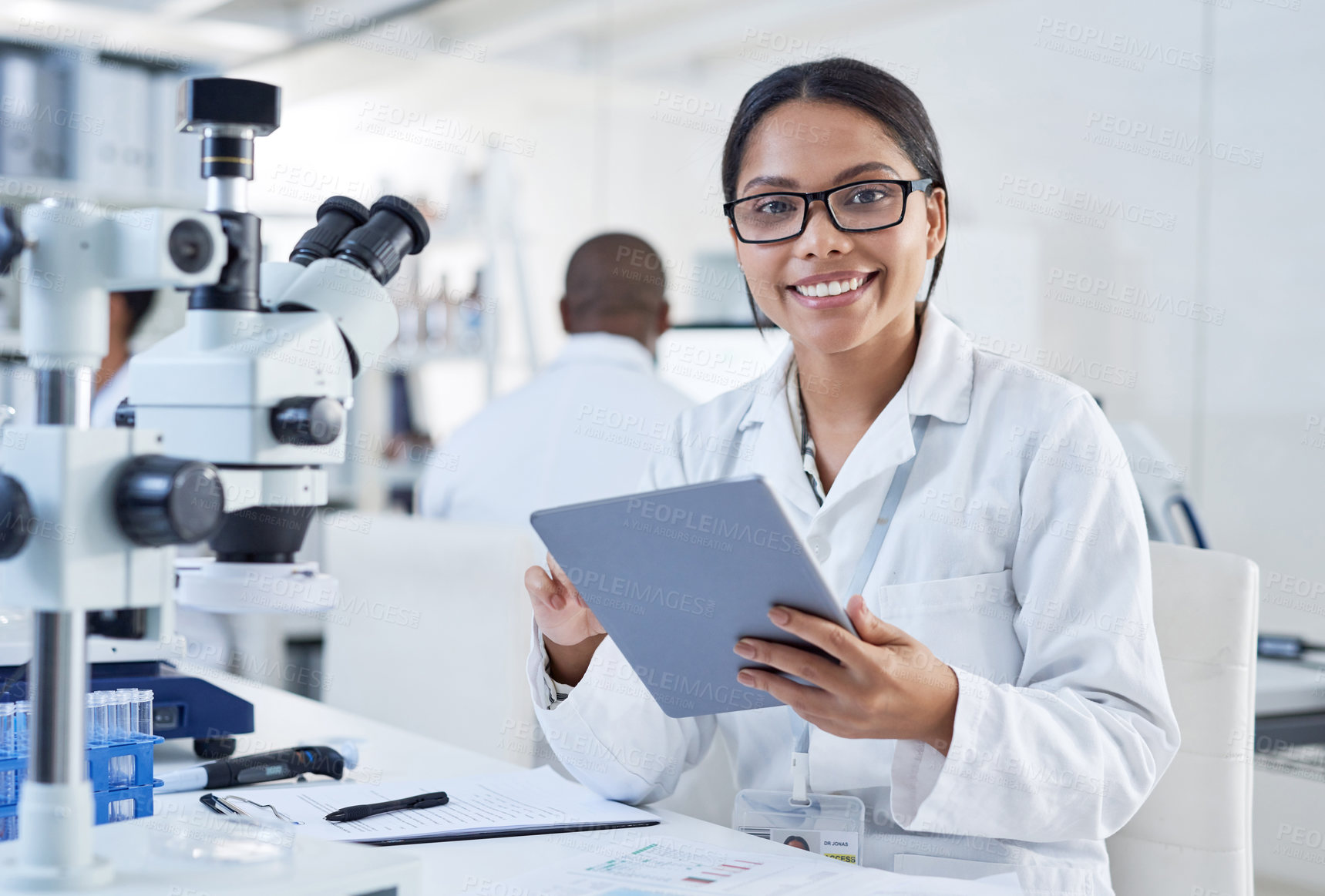 Buy stock photo Portrait of a young scientist using a digital tablet in a lab