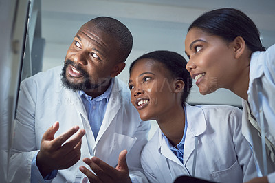 Buy stock photo Shot of a group of scientists conducting research in a laboratory