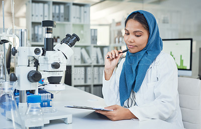 Buy stock photo Shot of a young scientist conducting research in a laboratory