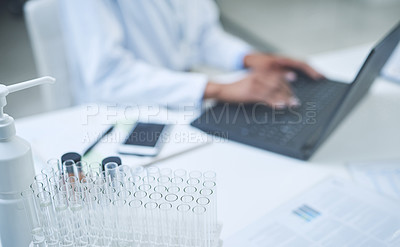 Buy stock photo Shot of an unrecognisable scientist using a laptop to conduct research in a laboratory