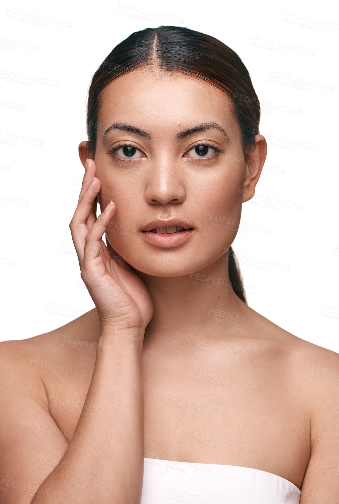 Buy stock photo Shot of a beautiful young woman touching her face while standing against a white background