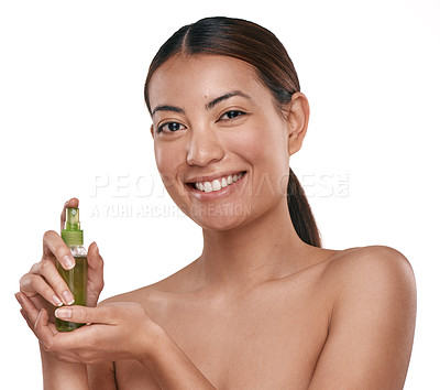 Buy stock photo Shot of a beautiful young woman holding up a bottle of face mist
