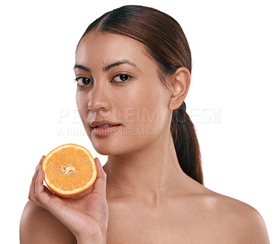 Buy stock photo Shot of a beautiful young woman holding a halved orange while posing against a white background