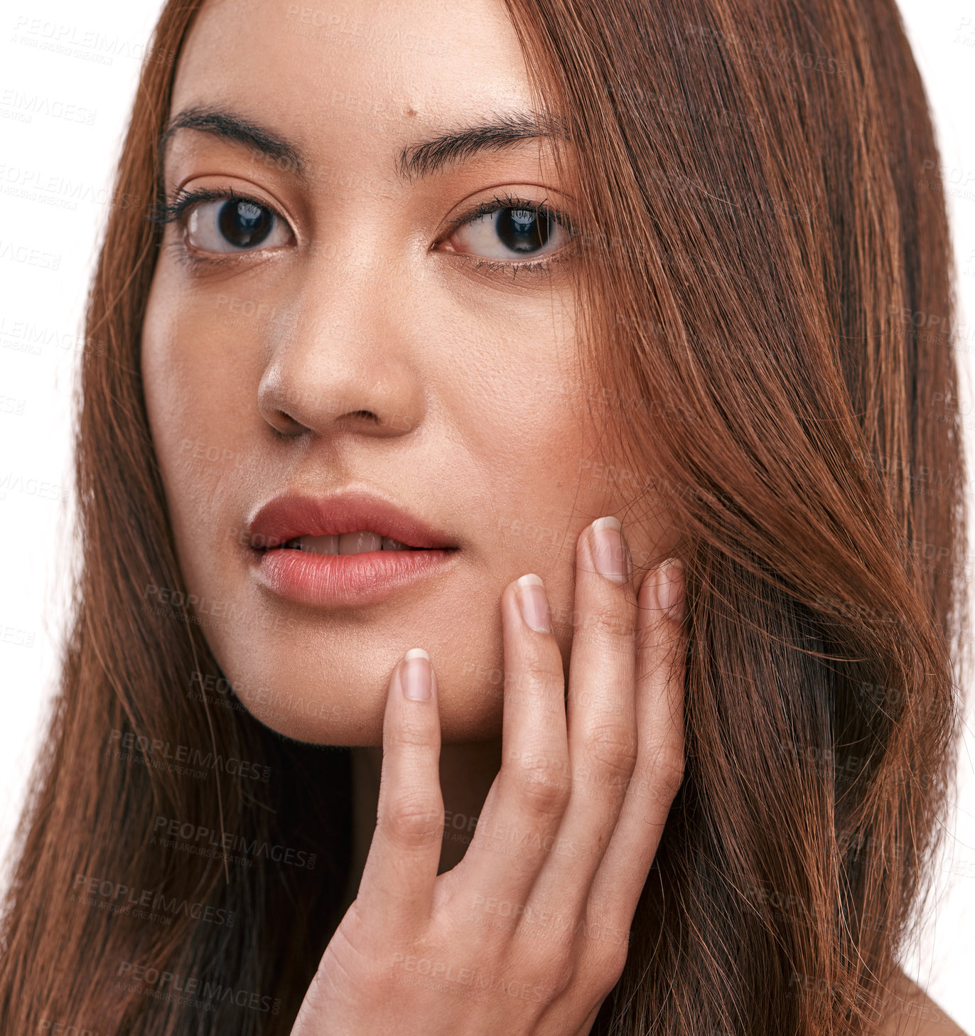 Buy stock photo Studio shot of a beautiful young woman with long brown hair against a white background