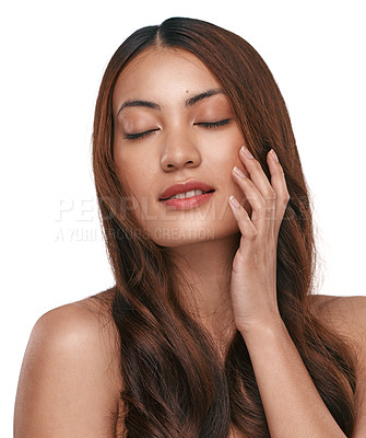 Buy stock photo Studio shot of a beautiful young woman with long brown hair against a white background