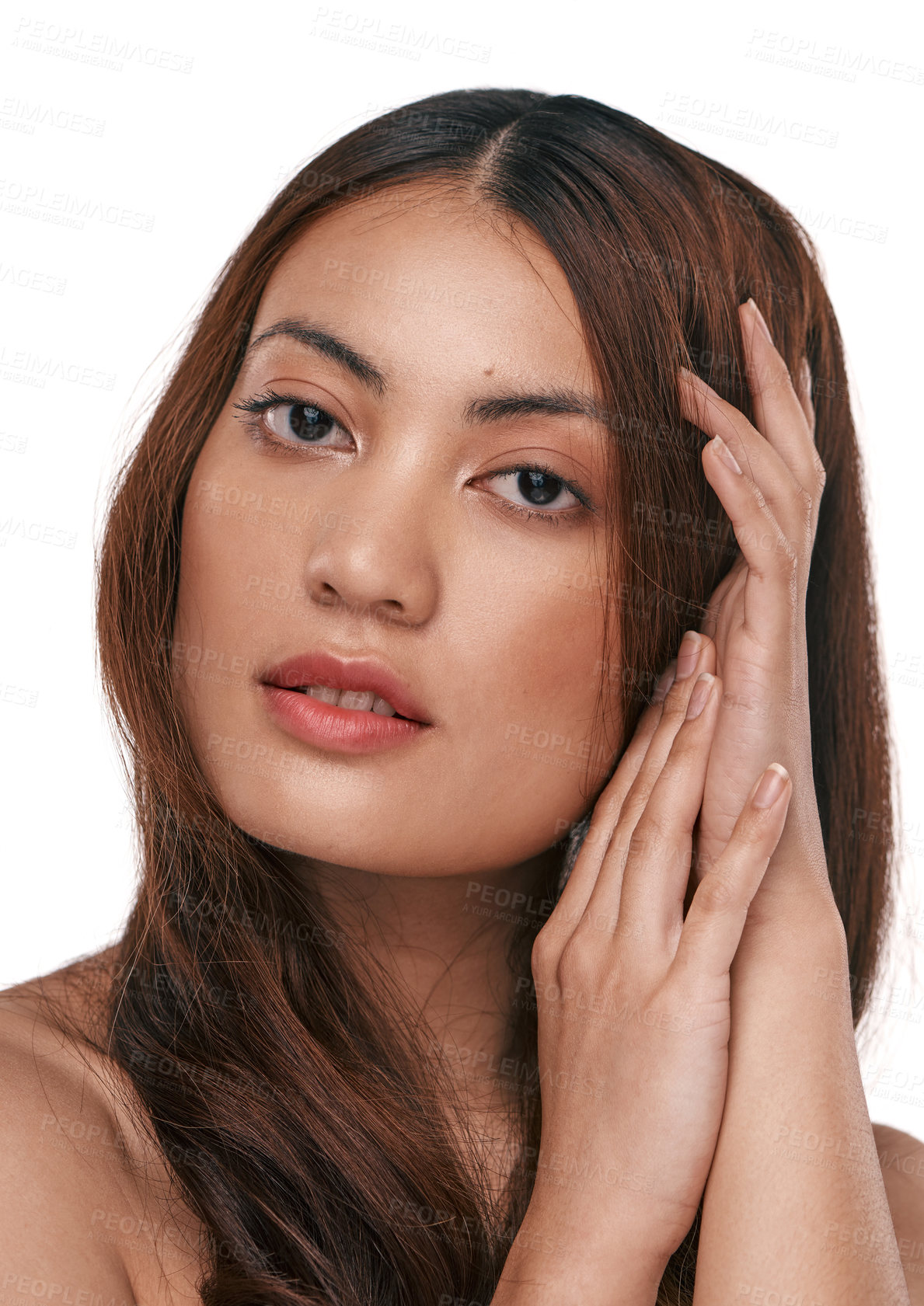 Buy stock photo Studio shot of a beautiful young woman with long brown hair against a white background