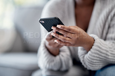 Buy stock photo Closeup of woman hands typing on phone, sending a text message online on social media on home sofa. Female reading and replying to a work email. African American lady playing a game on mobile device.