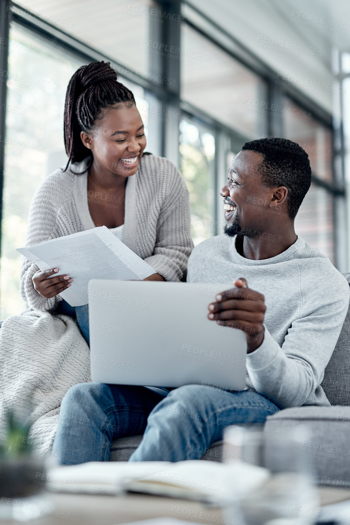 Buy stock photo Shot of a young couple going through paperwork at home