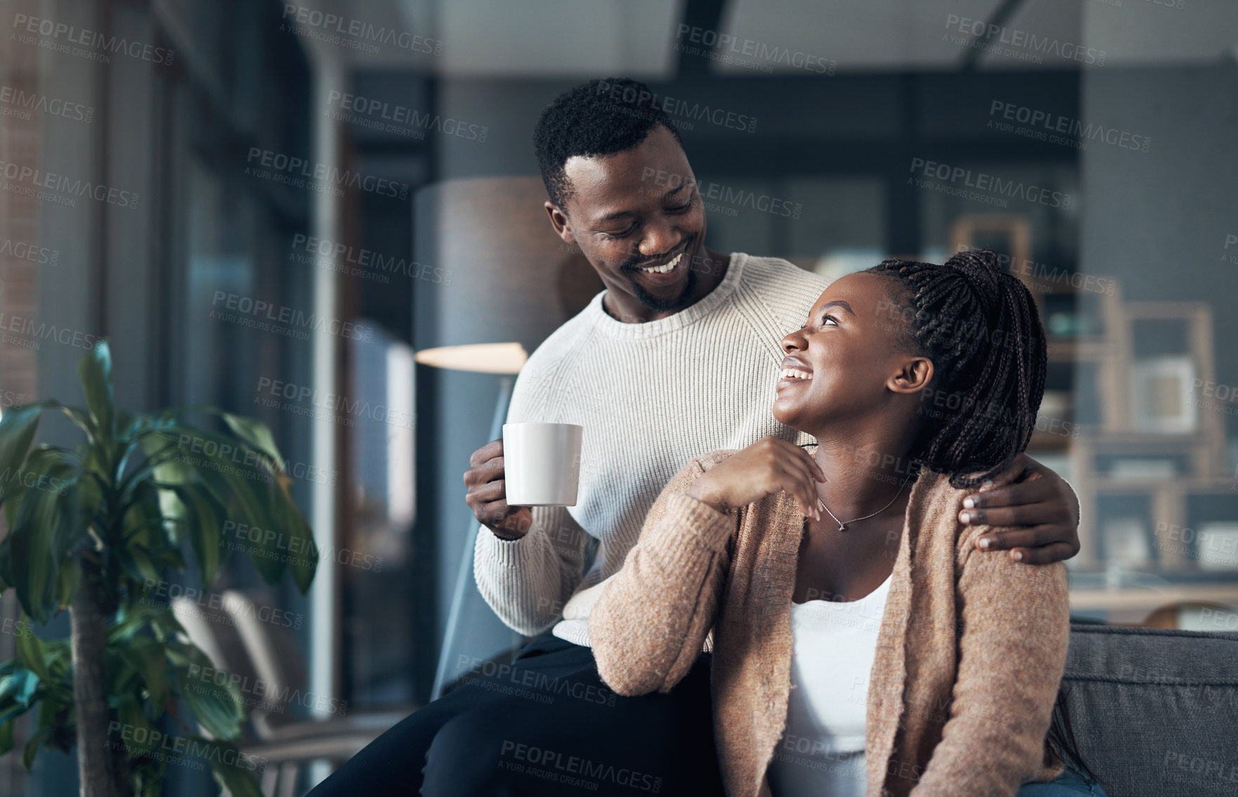 Buy stock photo Cropped shot of an affectionate young couple spending a relaxing day at home together