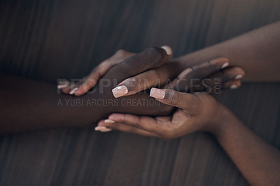 Buy stock photo Cropped shot of an unrecognizable couple holding hands while at home during the day