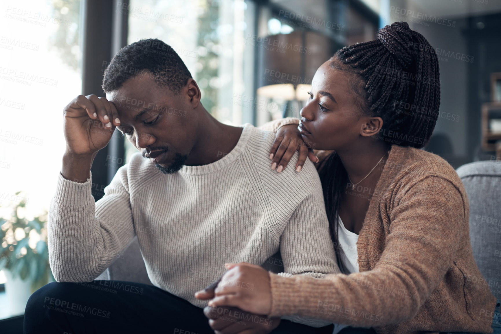 Buy stock photo Stress, comfort and black couple on sofa with concern for support, empathy and understanding. Marriage, home and woman with man for embrace for bonding, relationship and care for worry, sad or pain