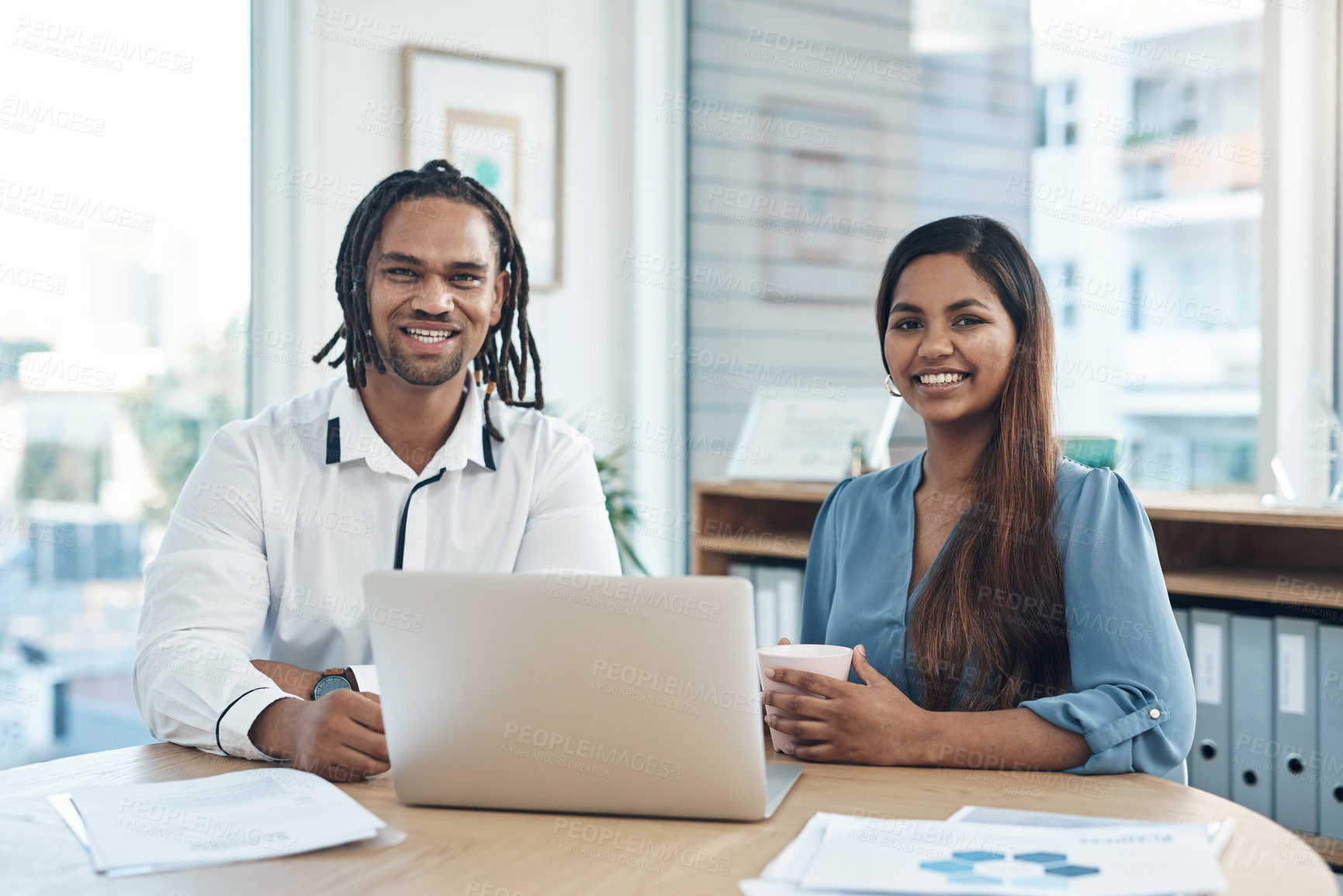 Buy stock photo Portrait of two businesspeople working together on a laptop in an office