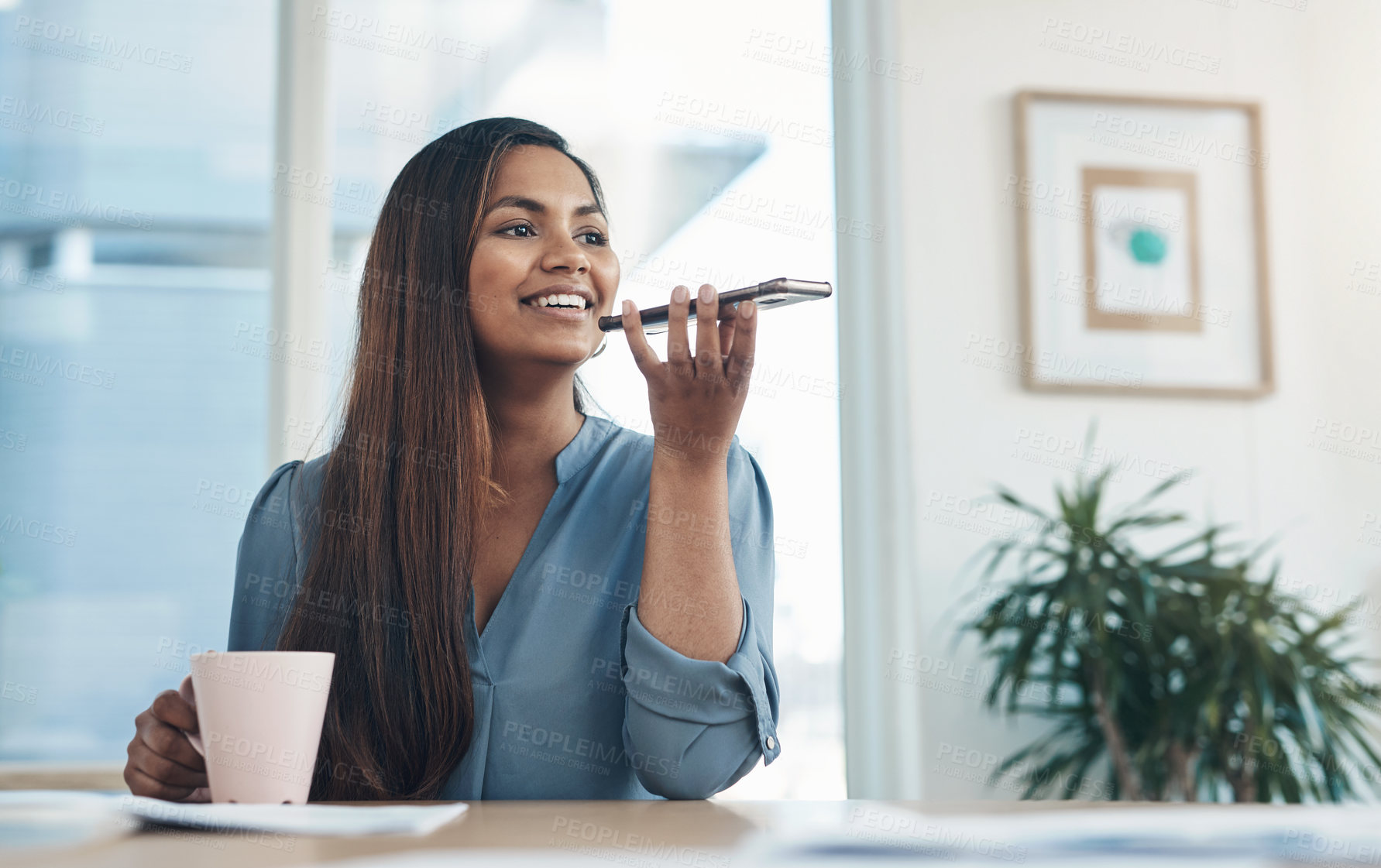 Buy stock photo Shot of a young businesswoman using a cellphone in an office