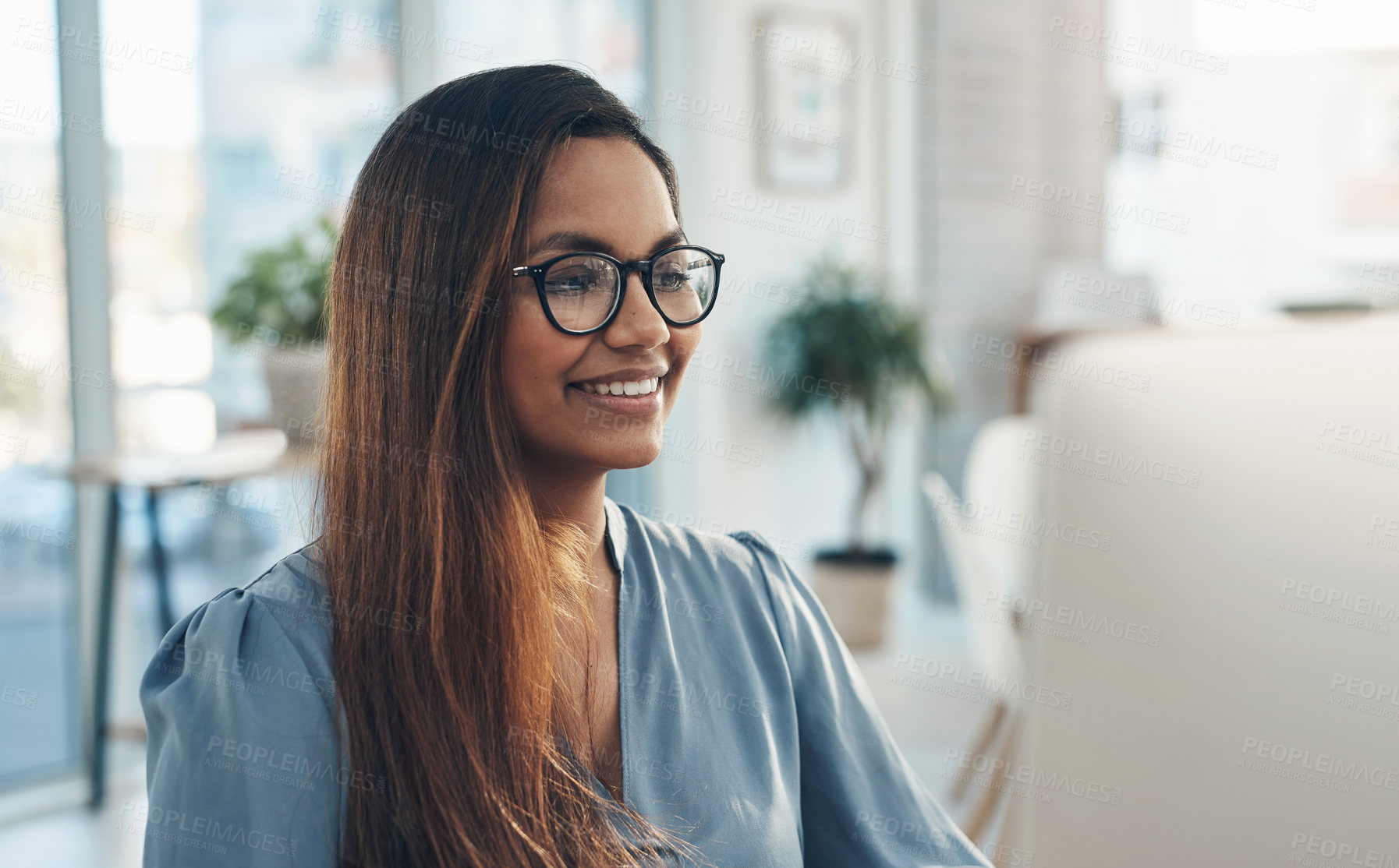 Buy stock photo Shot of a young businesswoman working on a computer in an office