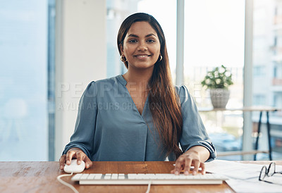 Buy stock photo Portrait of a young businesswoman using a computer in an office
