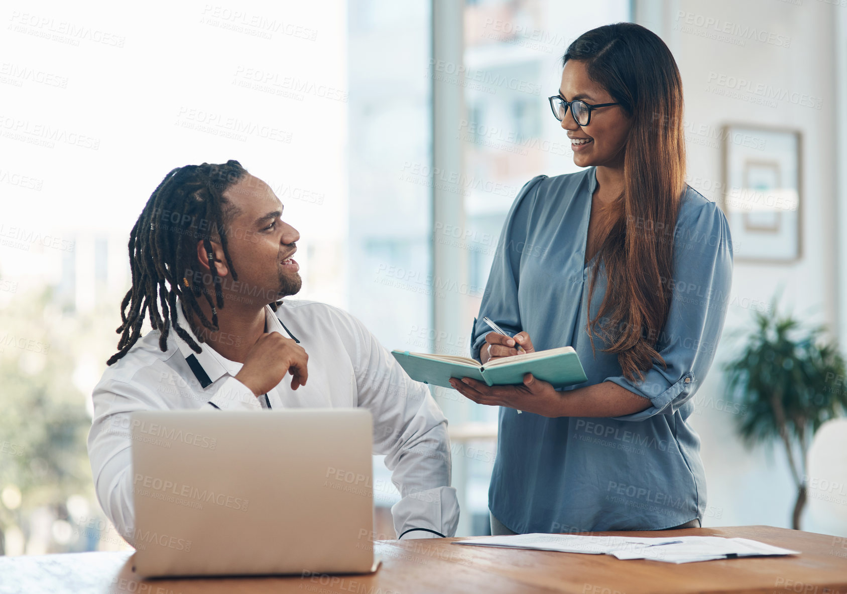 Buy stock photo Shot of two businesspeople having a discussion in an office