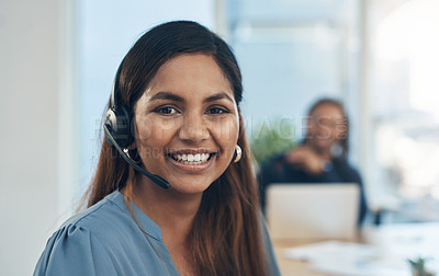 Buy stock photo Portrait of a young businesswoman wearing a headset while working in an office