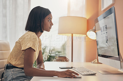 Buy stock photo Shot of a young woman using a computer while working from home