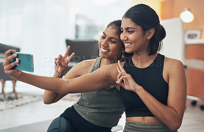 Buy stock photo Fitness, peace sign and selfie of women together at home for social media memory or post. Indian sisters or female friends with photo for influencer update, workout motivation or hand for happy emoji