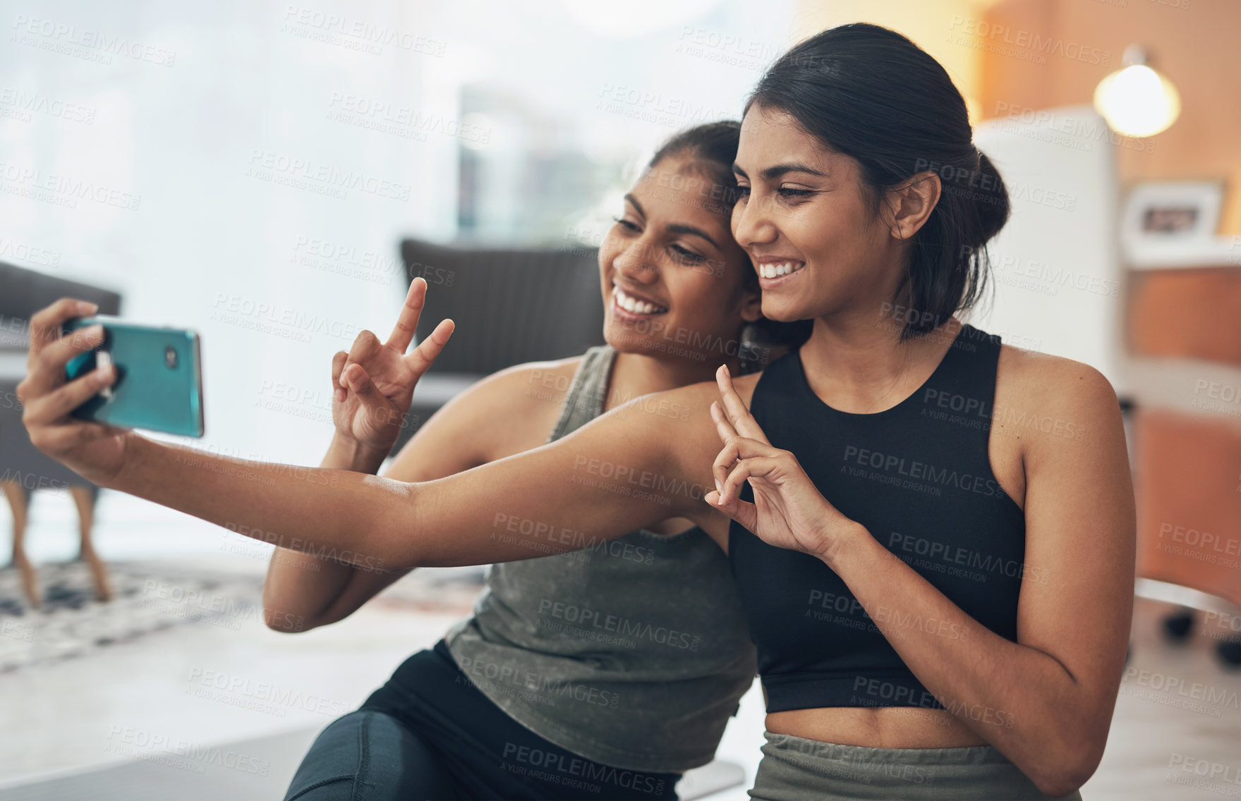 Buy stock photo Fitness, peace sign and selfie of women together at home for social media memory or post. Indian sisters or female friends with photo for influencer update, workout motivation or hand for happy emoji