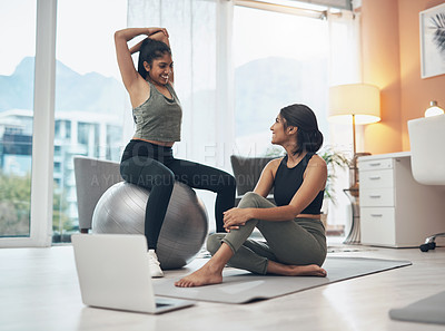 Buy stock photo Shot of two young women working out at home