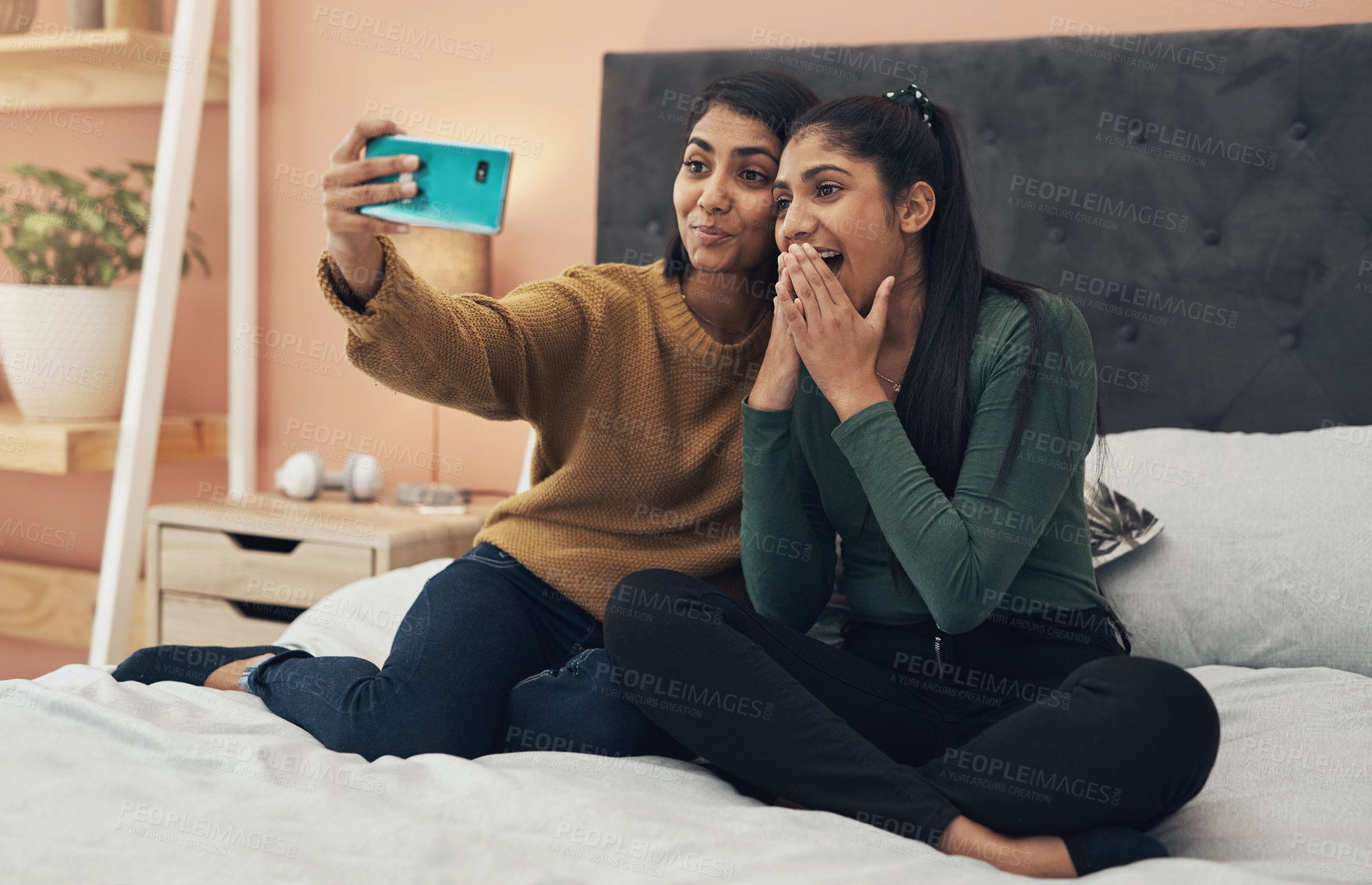 Buy stock photo Selfie, social media and surprise with sisters on bed in home together for bonding, love or memories. App, profile picture and wow with girl siblings in apartment for weekend photograph as family