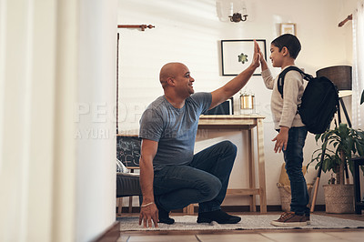 Buy stock photo Shot of an adorable little boy giving his father a high five before leaving to go to school