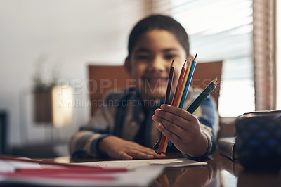 Buy stock photo Shot of an adorable little boy completing a school assignment at home