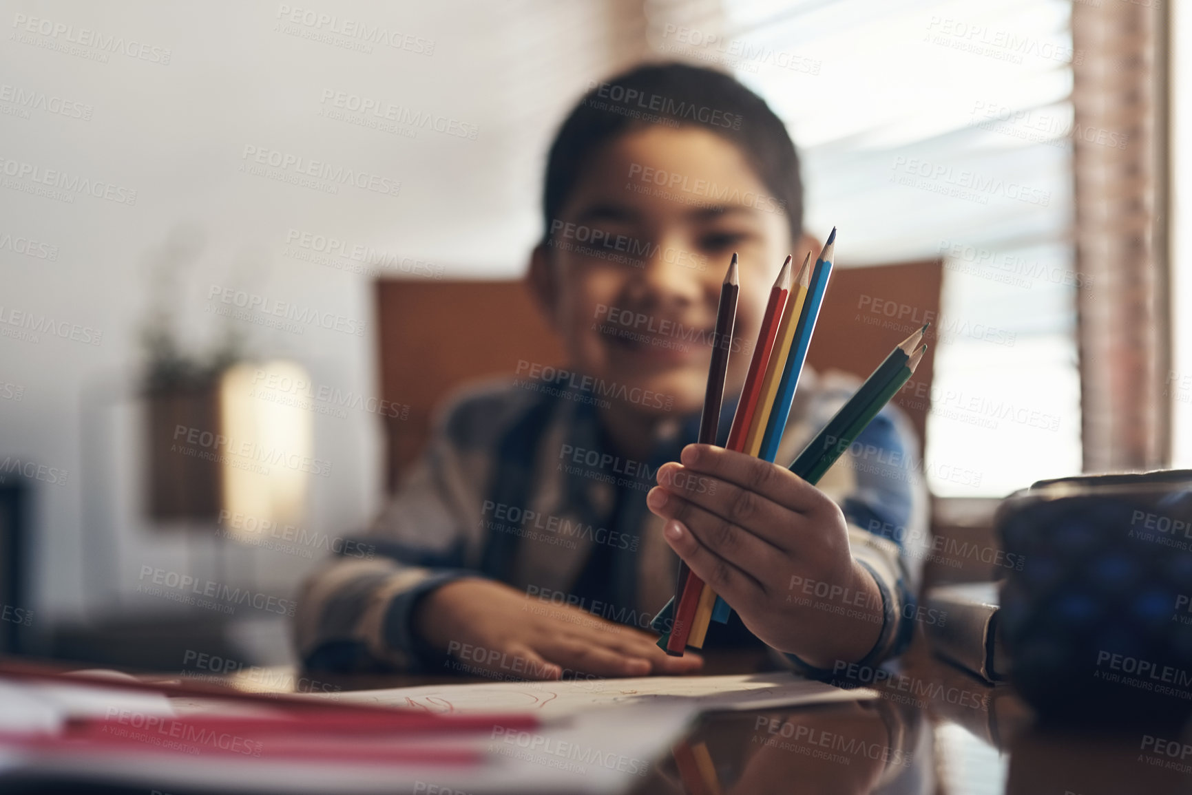 Buy stock photo Shot of an adorable little boy completing a school assignment at home