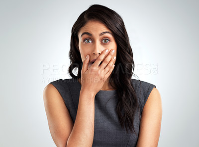 Buy stock photo Shot of a young woman looking shocked while posing against a white background