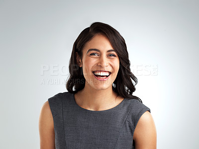 Buy stock photo Shot of a beautiful young woman laughing while standing against a white background