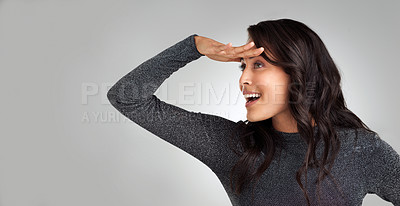 Buy stock photo Shot of a beautiful woman standing against a grey background