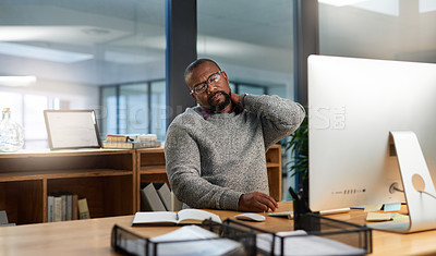 Buy stock photo Cropped shot of a handsome mature businessman sitting at his desk and suffering from neck ache during a late shift