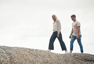 Buy stock photo Shot of a young couple spending the day together at the beach