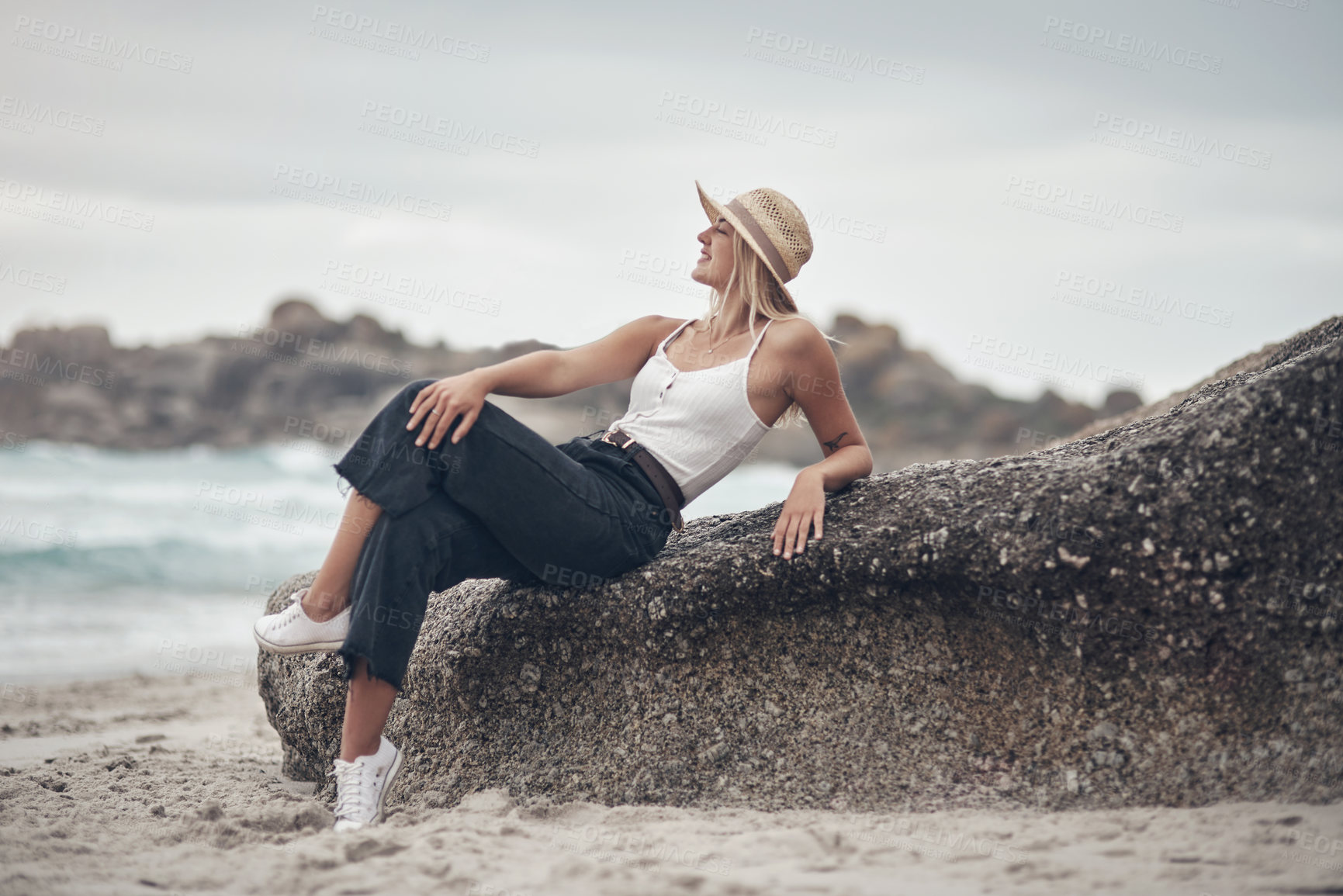 Buy stock photo Shot of a beautiful young woman spending the day at the beach