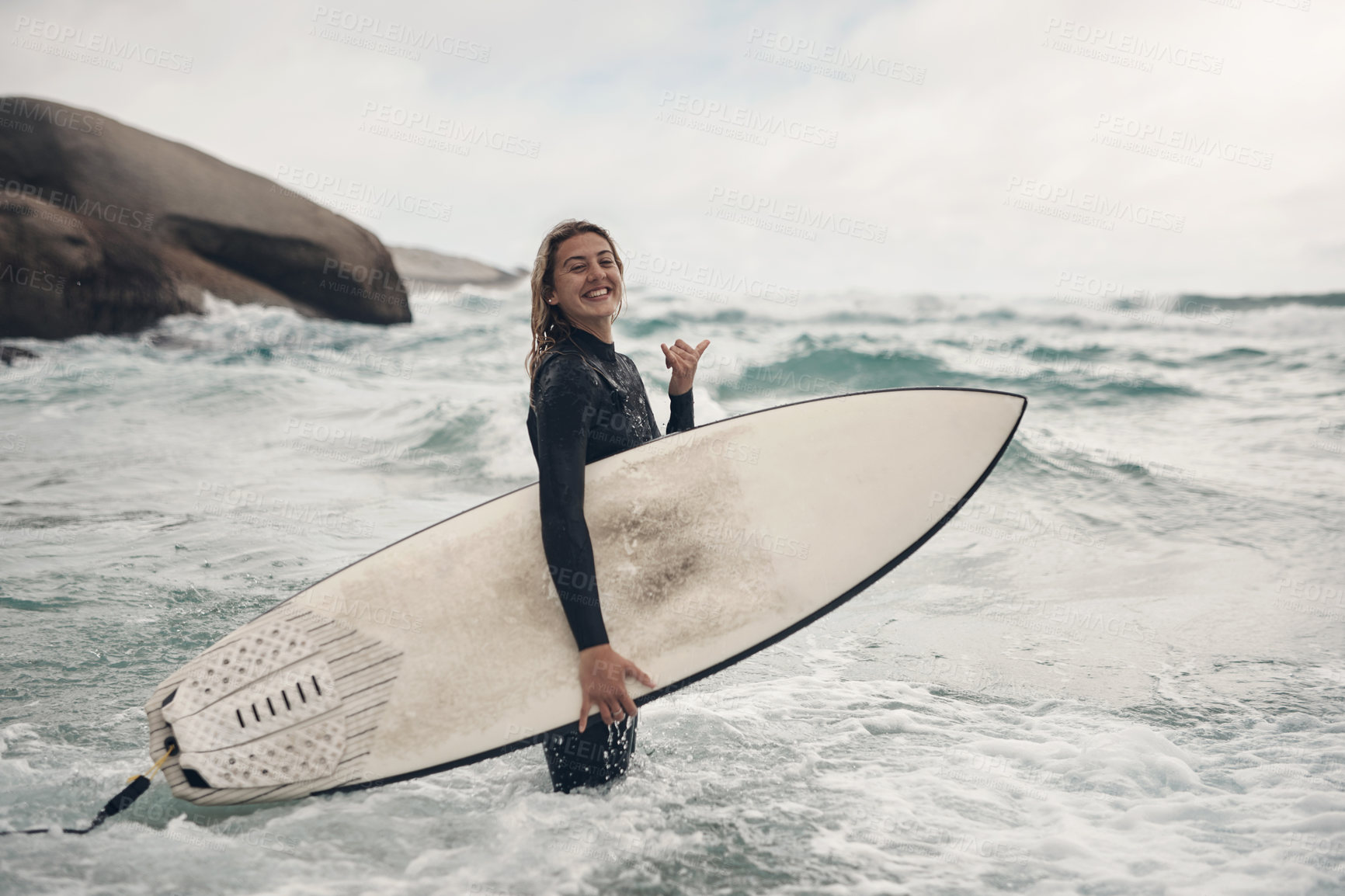 Buy stock photo Shot of a young woman out surfing at the beach