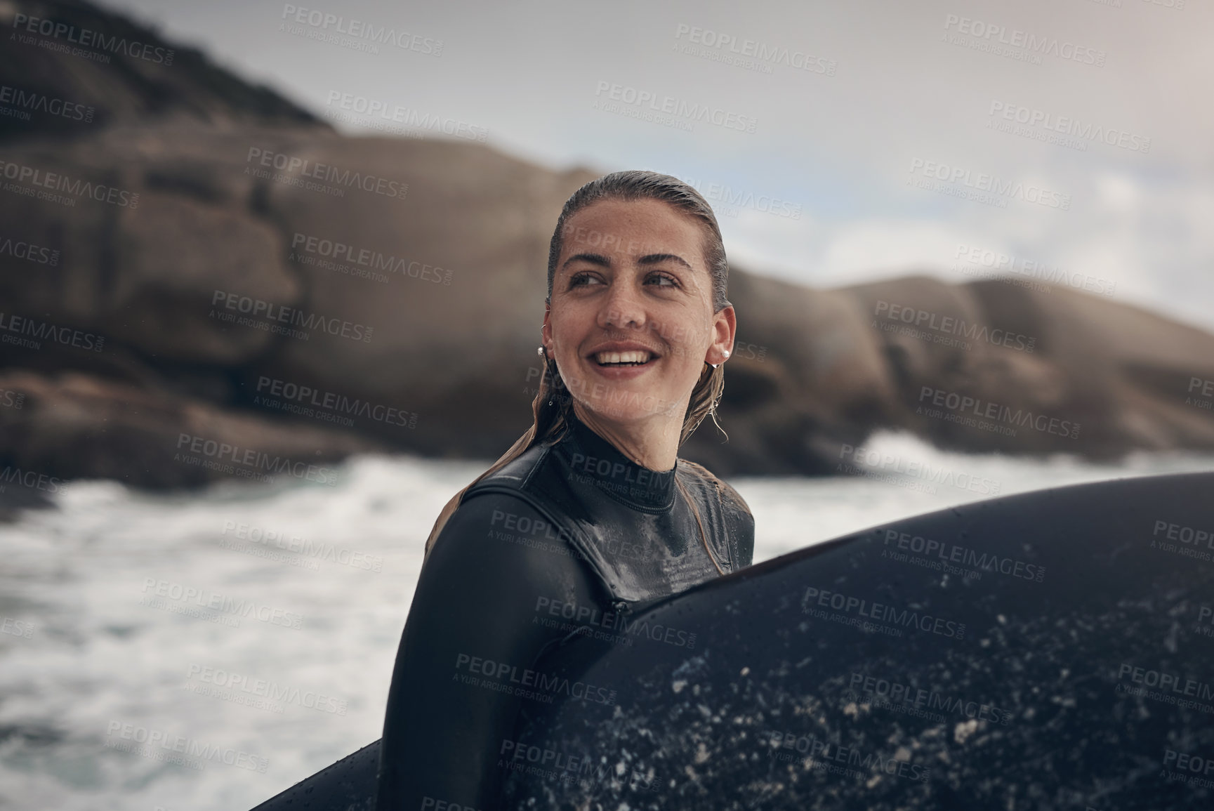 Buy stock photo Shot of a young woman out surfing at the beach