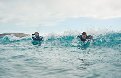Buy stock photo Shot of a young couple out surfing together at the beach