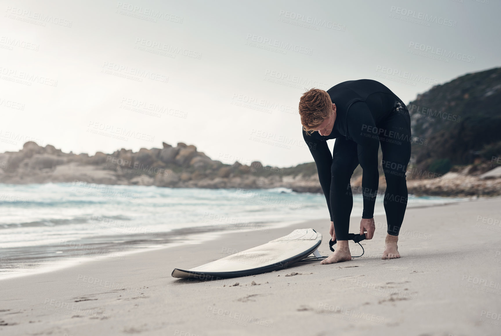 Buy stock photo Shot of a young man out surfing at the beach