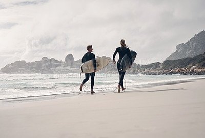 Buy stock photo Shot of a young couple out surfing together at the beach