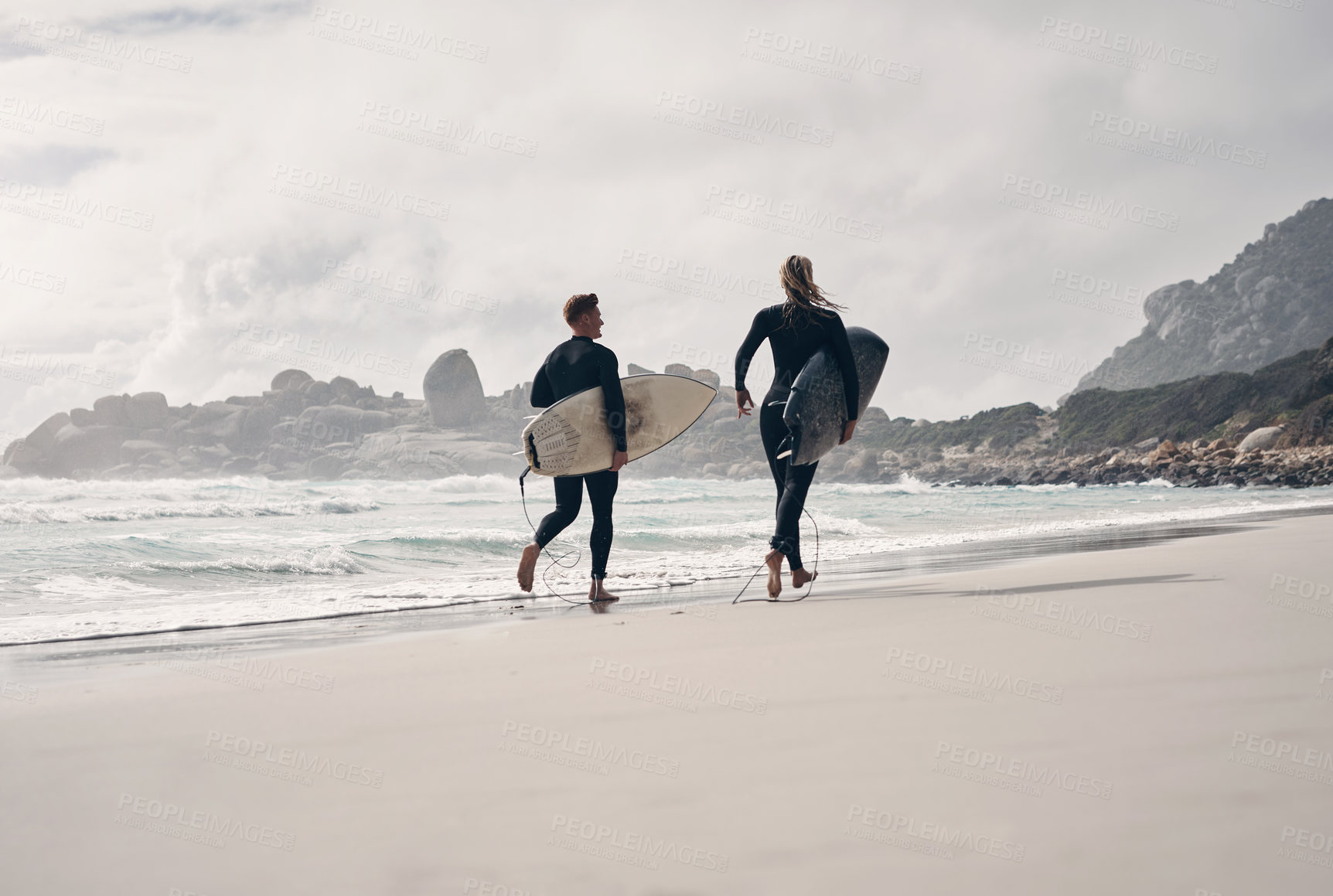 Buy stock photo Shot of a young couple out surfing together at the beach