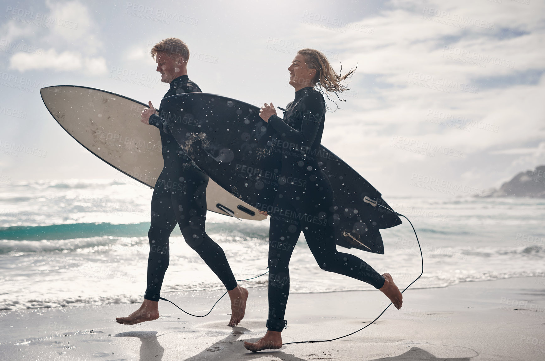 Buy stock photo Shot of a young couple out surfing together at the beach