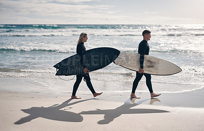 Buy stock photo Shot of a young couple out surfing together at the beach