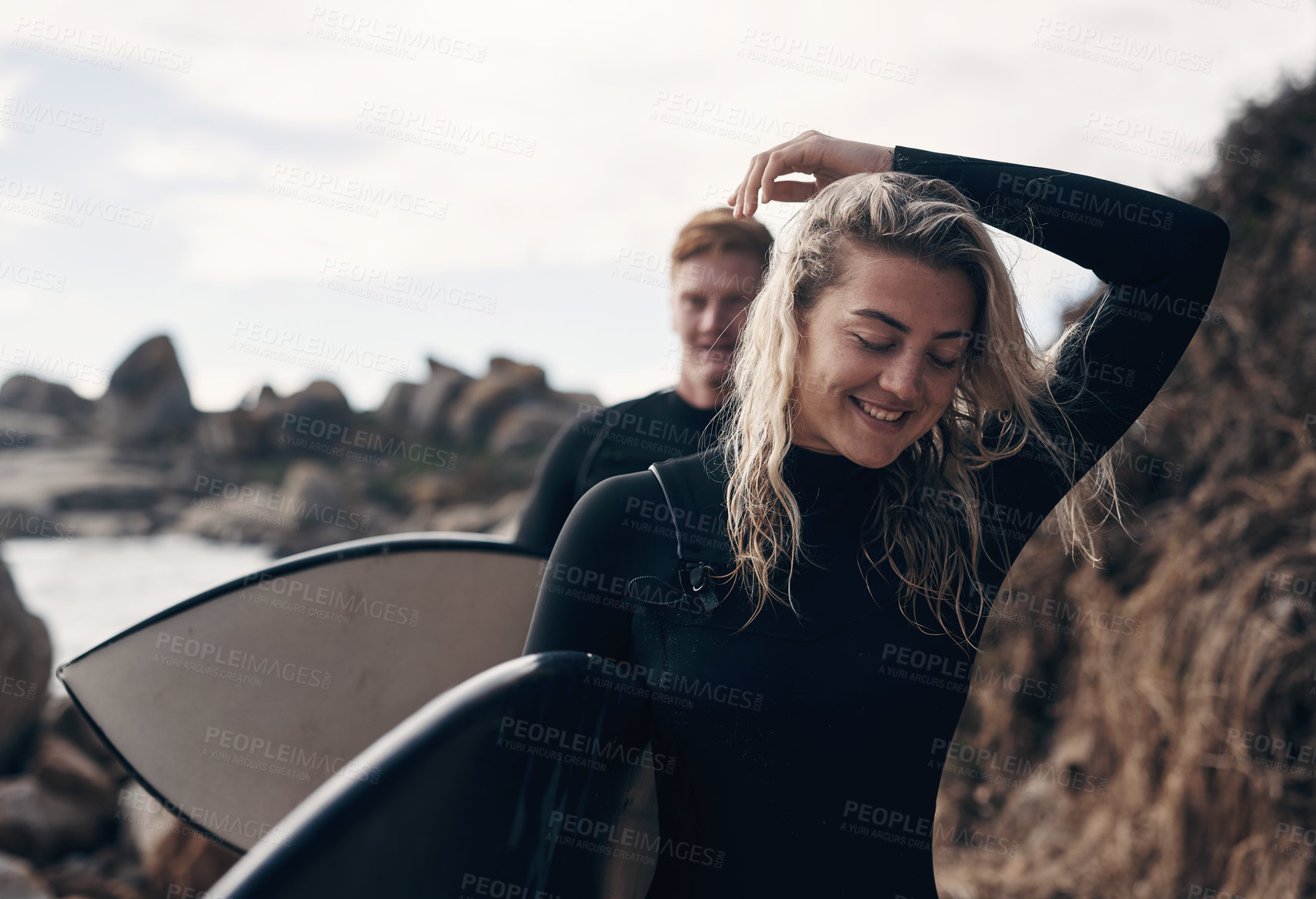 Buy stock photo Shot of a young couple out surfing together at the beach