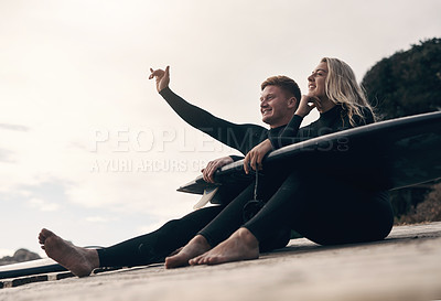 Buy stock photo Shot of a young couple out surfing together at the beach