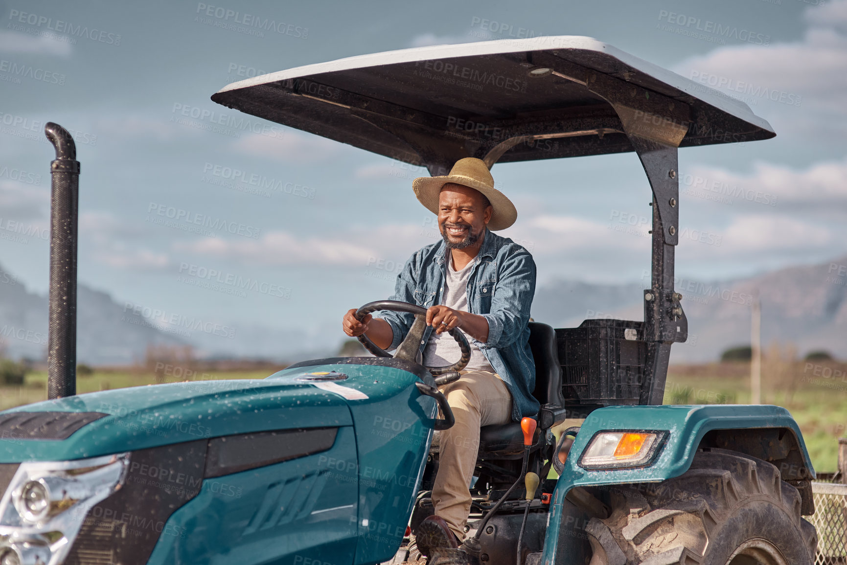 Buy stock photo Shot of a mature man driving a tractor on a farm
