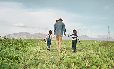 Buy stock photo Rearview shot of a man and his two adorable children exploring a farm